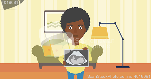 Image of Pregnant woman with ultrasound image.