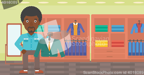 Image of Man holding suit jacket in clothing store.