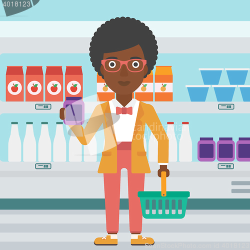 Image of Customer with shopping basket and tube of cream.