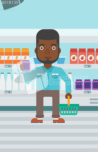 Image of Customer with shopping basket and tube of cream.
