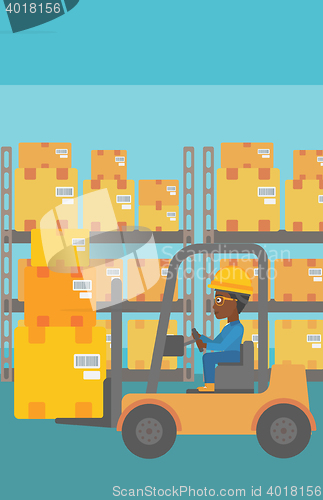 Image of Warehouse worker moving load by forklift truck.