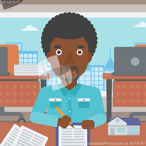 Image of Real estate agent signing contract.