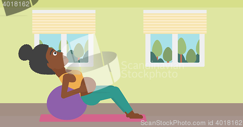 Image of Pregnant woman on gymnastic ball.