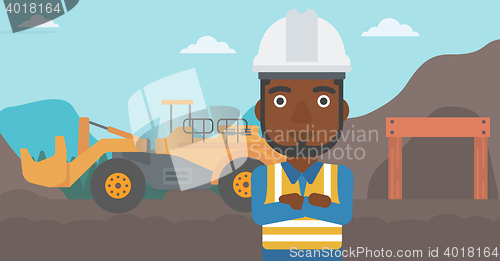 Image of Miner with mining equipment on background.