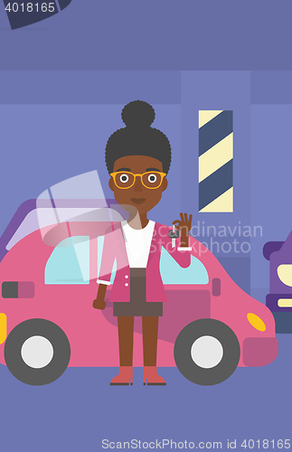 Image of Woman holding keys to her new car.