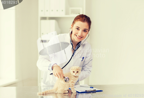 Image of happy veterinarian with kitten at vet clinic