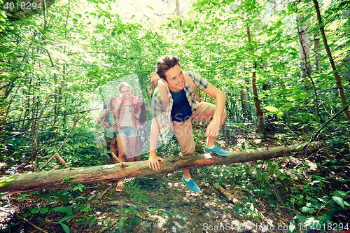 Image of group of smiling friends with backpacks hiking