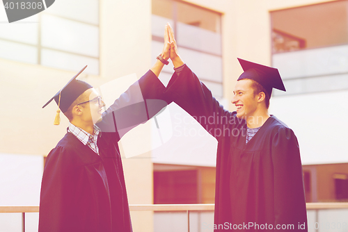 Image of smiling students in mortarboards