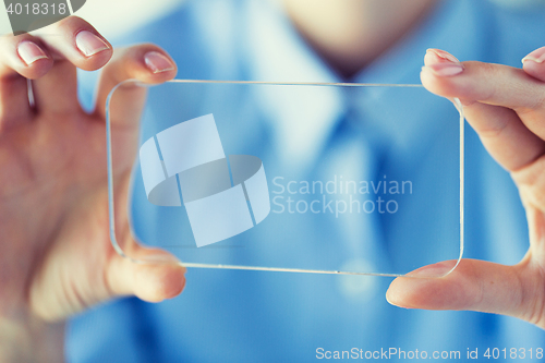 Image of close up of woman with transparent smartphone