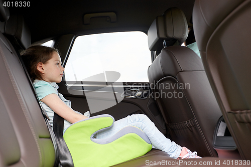 Image of family with child in safety seat driving car