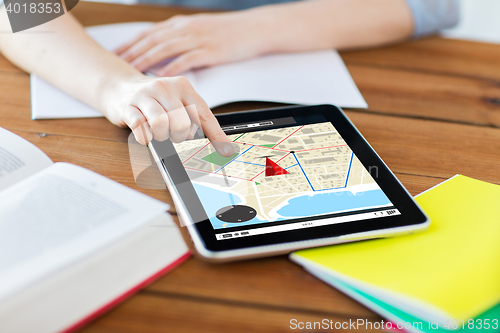 Image of close up of student with tablet pc and notebook