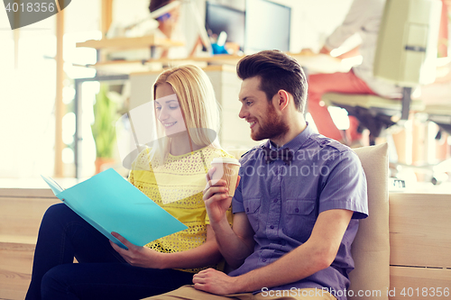 Image of office workers with folder and coffee
