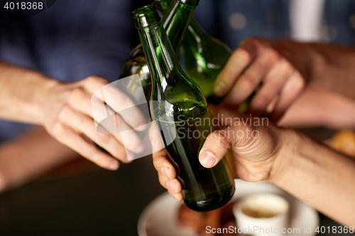 Image of close up of friends drinking beer at bar or pub