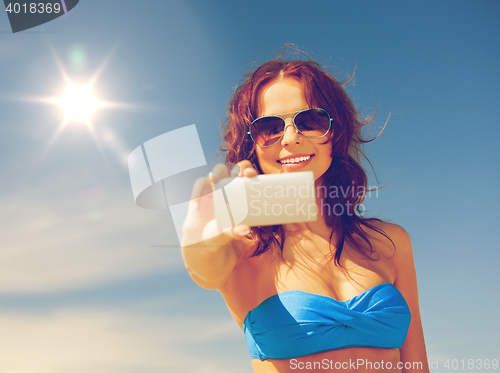 Image of happy woman with phone on the beach