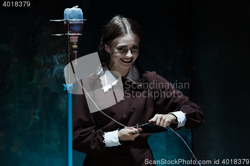 Image of Portrait of a young girl in school uniform as killer woman