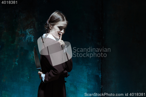 Image of Portrait of a young girl in school uniform as killer woman