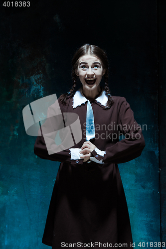 Image of Portrait of a young girl in school uniform as killer woman