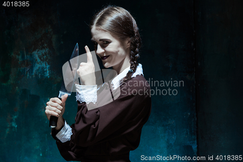 Image of Portrait of a young girl in school uniform as killer woman