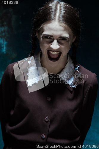 Image of Portrait of a young smiling girl in school uniform as killer woman