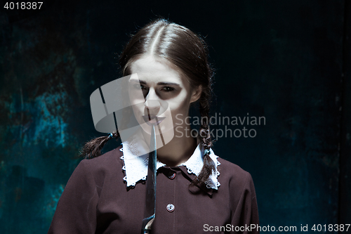 Image of Portrait of a young girl in school uniform as killer woman