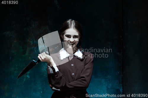 Image of Portrait of a young girl in school uniform as killer woman