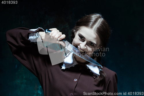 Image of Portrait of a young girl in school uniform as killer woman