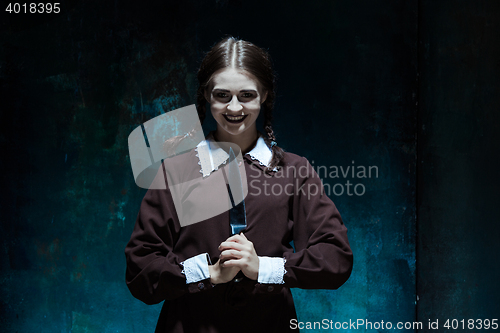 Image of Portrait of a young girl in school uniform as killer woman