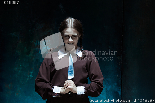 Image of Portrait of a young girl in school uniform as killer woman