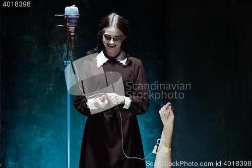 Image of Portrait of a young girl in school uniform as killer woman