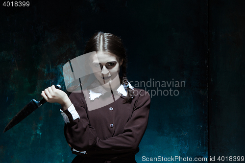 Image of Portrait of a young girl in school uniform as killer woman