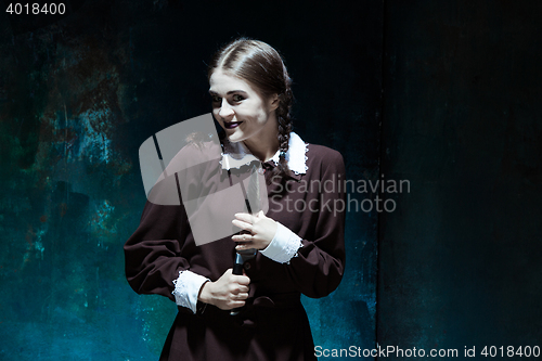 Image of Portrait of a young girl in school uniform as killer woman