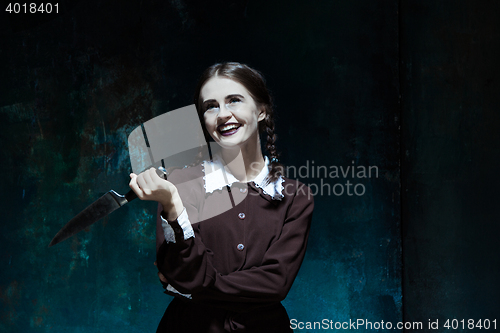 Image of Portrait of a young girl in school uniform as killer woman