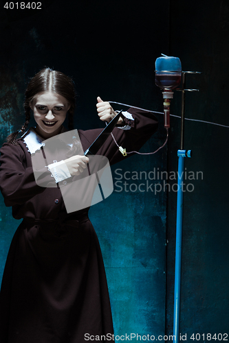 Image of Portrait of a young girl in school uniform as killer woman