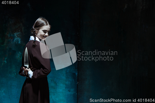 Image of Portrait of a young girl in school uniform as killer woman