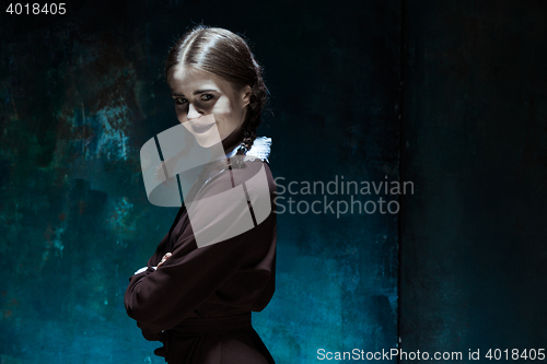 Image of Portrait of a young smiling girl in school uniform as killer woman