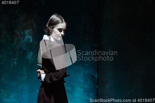 Image of Portrait of a young girl in school uniform as killer woman
