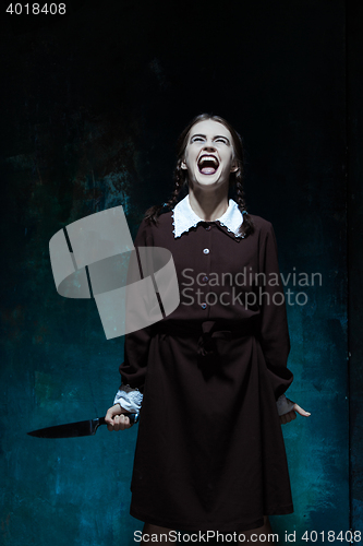 Image of Portrait of a young girl in school uniform as killer woman