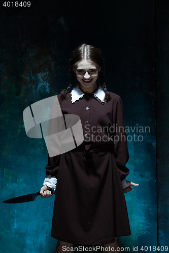 Image of Portrait of a young girl in school uniform as killer woman