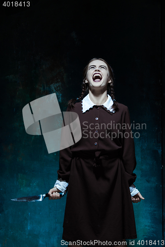 Image of Portrait of a young girl in school uniform as killer woman