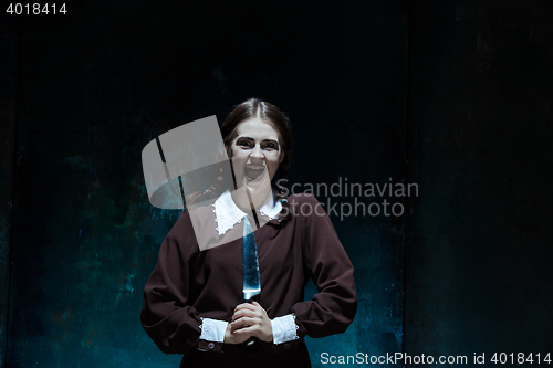 Image of Portrait of a young girl in school uniform as killer woman