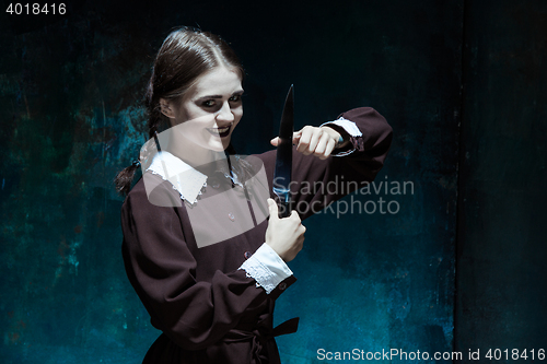 Image of Portrait of a young girl in school uniform as killer woman