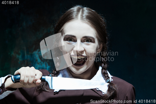 Image of Portrait of a young girl in school uniform as killer woman