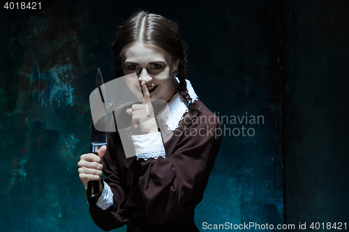 Image of Portrait of a young girl in school uniform as killer woman