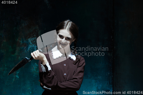 Image of Portrait of a young girl in school uniform as killer woman