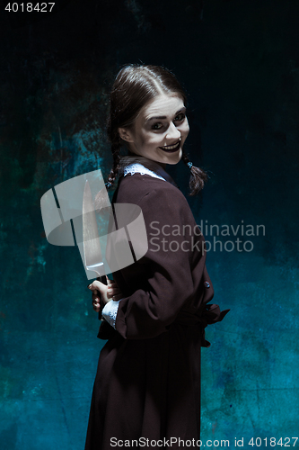 Image of Portrait of a young girl in school uniform as killer woman