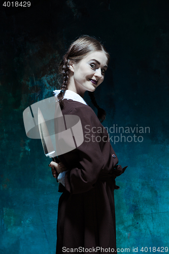 Image of Portrait of a young girl in school uniform as killer woman