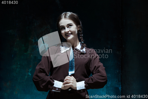 Image of Portrait of a young girl in school uniform as killer woman