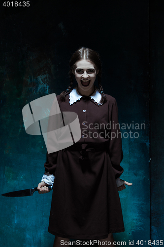 Image of Portrait of a young girl in school uniform as killer woman