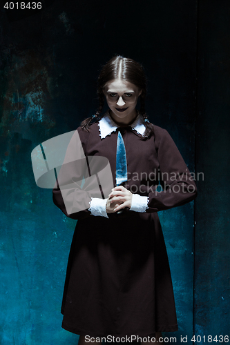 Image of Portrait of a young girl in school uniform as killer woman