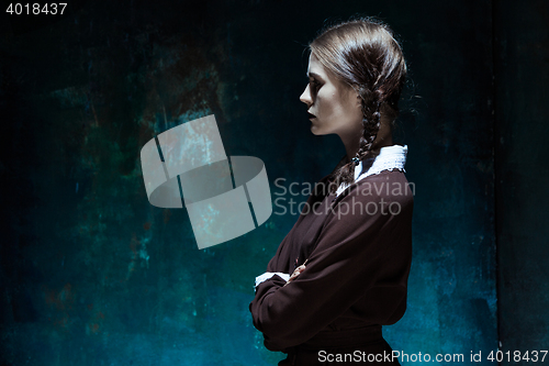 Image of Portrait of a young girl in school uniform as killer woman